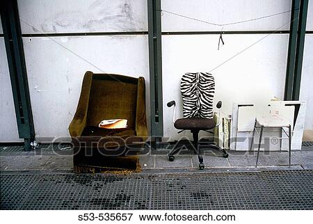 Stock Photo - Discarded chairs against a wall at the Pompidou Center. Fotosearch