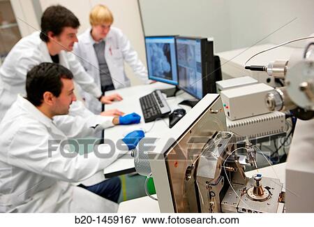 Discussing on SEM images, Analysis of nanostructures and nanodevices, Environmental scanning electron microscopy Laboratory, ESEM, Microscope Quanta TM 250 FEG, High-resolution surface imaging, Investigation of wet and dielectric samples View Large Photo Image Stock Photo - Discussing on SEM images, Analysis of nanostructures and nanodevices, Environmental scanning electron microscopy Laboratory, ESEM, Microscope Quanta TM 250 FEG, High-resolution surface imaging, Investigation of wet and dielectric samples. Fotosearch