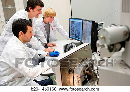 Stock Photo - Discussing on SEM images, Analysis of nanostructures and nanodevices, Environmental scanning electron microscopy Laboratory, ESEM, Microscope Quanta TM 250 FEG, High-resolution surface imaging, Investigation of wet and dielectric samples. Fotosearch