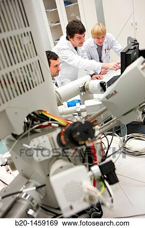 Discussing on SEM images, Analysis of nanostructures and nanodevices, Environmental scanning electron microscopy Laboratory, ESEM, Microscope Quanta TM 250 FEG, High-resolution surface imaging, Investigation of wet and dielectric samples View Large Photo Image Stock Photo - Discussing on SEM images, Analysis of nanostructures and nanodevices, Environmental scanning electron microscopy Laboratory, ESEM, Microscope Quanta TM 250 FEG, High-resolution surface imaging, Investigation of wet and dielectric samples. Fotosearch