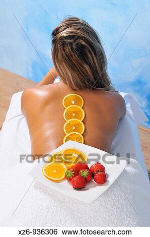 Dish with oranges and strawberries in the back of a young woman for a natural beauty treatment View Large Photo Image Stock Photograph - Dish with oranges and strawberries in the back of a young woman for a natural beauty treatment. Fotosearch