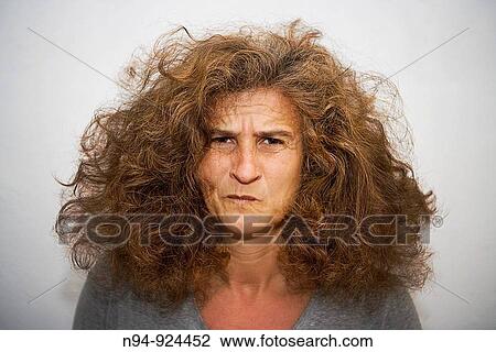 Stock Image - Disheveled woman with an expression of pain.. Fotosearch