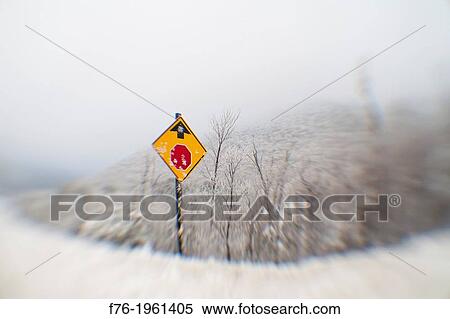 Distorted and blurred lensbaby photograph of a roadsign in snow warning of a coming stop sign ahead. View Large Photo Image Stock Photography - Distorted and blurred lensbaby photograph of a roadsign in snow warning of a coming stop sign ahead.. Fotosearch