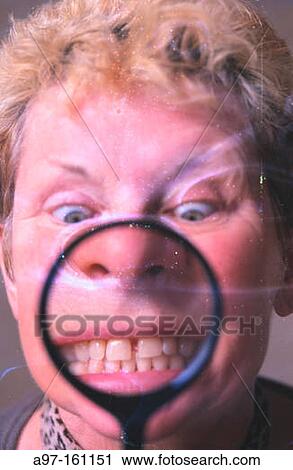 Distorted woman looks through magnifying glass View Large Photo Image Stock Image - Distorted woman looks through magnifying glass. Fotosearch