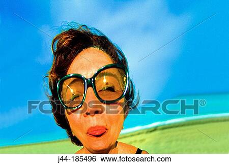 Distorted woman's face with sun glasses View Large Photo Image Stock Photograph - Distorted woman's face with sun glasses. Fotosearch