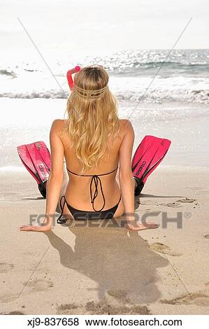 Diver girl seat on the shoreline lookin the horizon in Tenerife beach. View Large Photo Image Stock Photo - Diver girl seat on the shoreline lookin the horizon in Tenerife beach.. Fotosearch