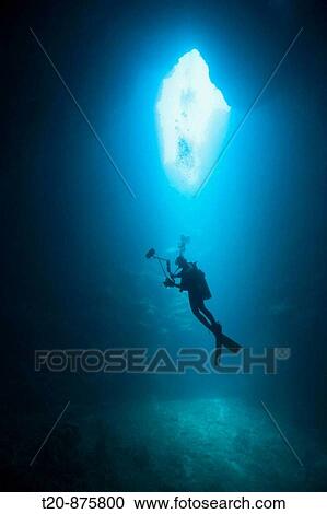 Stock Image - Diver in Siaes Tunnel Cave, Micronesia, Palau. Fotosearch