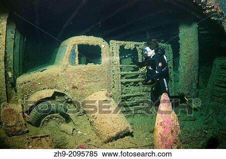 Diver looking at truck on shipwreck """"SS Thistlegorm"""". Red sea, Egypt, Africa. "" View Large Photo Image Stock Photography - Diver looking at truck on shipwreck """"SS Thistlegorm"""". Red sea, Egypt, Africa. "". Fotosearch