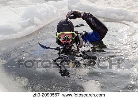 Diver, preparing for subglacial diving, ice diving, in the frozen Black Sea, a rare phenomenon, last time it occured in 1977, Odessa, Ukraine, Eastern Europe. View Large Photo Image Stock Photo - Diver, preparing for subglacial diving, ice diving, in the frozen Black Sea, a rare phenomenon, last time it occured in 1977, Odessa, Ukraine, Eastern Europe.. Fotosearch