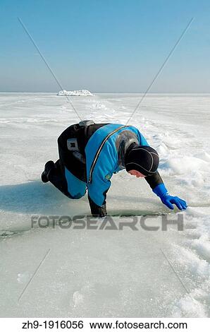 Diver, preparing for subglacial diving, ice diving, in the frozen Black Sea, a rare phenomenon, last time it occured in 1977, Odessa, Ukraine, Eastern Europe View Large Photo Image Stock Photograph - Diver, preparing for subglacial diving, ice diving, in the frozen Black Sea, a rare phenomenon, last time it occured in 1977, Odessa, Ukraine, Eastern Europe. Fotosearch