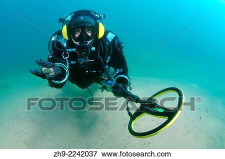 Diver with the metal detector displays the found ancient coins, lake Baikal, Siberia, Russia, Eurasia. View Large Photo Image Stock Photo - Diver with the metal detector displays the found ancient coins, lake Baikal, Siberia, Russia, Eurasia.. Fotosearch