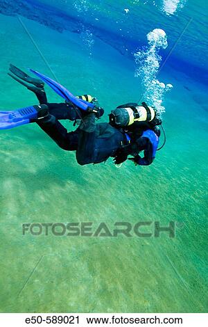 Stock Image - Divers, Silfra Fissure, Thingvellir National Park-World Heritage Site, near Reykjavik, Iceland. Fotosearch