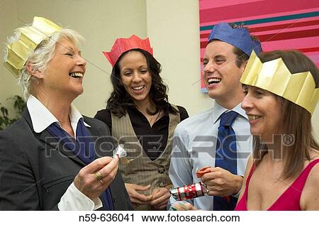 Diverse business team having fun at their office Christmas party. View Large Photo Image Stock Image - Diverse business team having fun at their office Christmas party.. Fotosearch