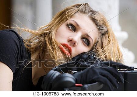 Stock Photo - DJ girl with bright Red lips tired. Fotosearch