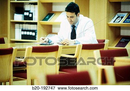 Doctor at library of hospital View Large Photo Image Stock Photo - Doctor at library of hospital. Fotosearch