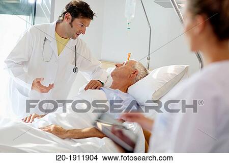 Doctor attending to patient in hospital room, Onkologikoa Hospital, Oncology Institute, Case Center for prevention, diagnosis and treatment of cancer, Donostia, San Sebastian, Gipuzkoa, Basque Country, Spain View Large Photo Image Picture - Doctor attending to patient in hospital room, Onkologikoa Hospital, Oncology Institute, Case Center for prevention, diagnosis and treatment of cancer, Donostia, San Sebastian, Gipuzkoa, Basque Country, Spain. Fotosearch