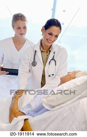 doctor attending to patient in hospital room, Onkologikoa Hospital, Oncology Institute, Case Center for prevention, diagnosis and treatment of cancer, Donostia, San Sebastian, Gipuzkoa, Basque Country, Spain View Large Photo Image Picture - doctor attending to patient in hospital room, Onkologikoa Hospital, Oncology Institute, Case Center for prevention, diagnosis and treatment of cancer, Donostia, San Sebastian, Gipuzkoa, Basque Country, Spain. Fotosearch