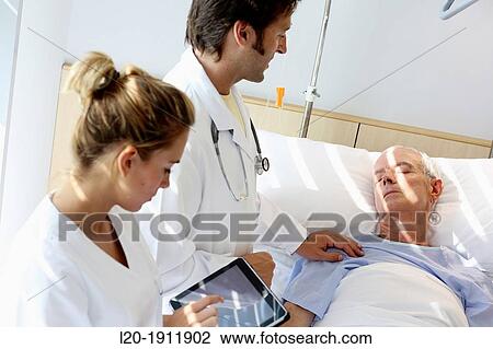doctor attending to patient in hospital room, Onkologikoa Hospital, Oncology Institute, Case Center for prevention, diagnosis and treatment of cancer, Donostia, San Sebastian, Gipuzkoa, Basque Country, Spain View Large Photo Image Stock Image - doctor attending to patient in hospital room, Onkologikoa Hospital, Oncology Institute, Case Center for prevention, diagnosis and treatment of cancer, Donostia, San Sebastian, Gipuzkoa, Basque Country, Spain. Fotosearch