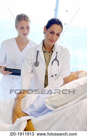doctor attending to patient in hospital room, Onkologikoa Hospital, Oncology Institute, Case Center for prevention, diagnosis and treatment of cancer, Donostia, San Sebastian, Gipuzkoa, Basque Country, Spain View Large Photo Image Stock Image - doctor attending to patient in hospital room, Onkologikoa Hospital, Oncology Institute, Case Center for prevention, diagnosis and treatment of cancer, Donostia, San Sebastian, Gipuzkoa, Basque Country, Spain. Fotosearch