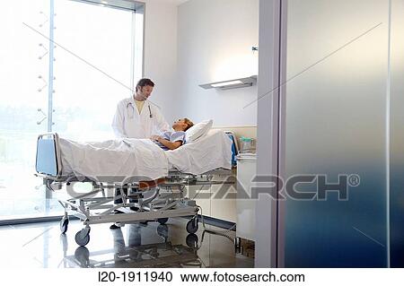 Stock Image - doctor attending to patient in hospital room, Onkologikoa Hospital, Oncology Institute, Case Center for prevention, diagnosis and treatment of cancer, Donostia, San Sebastian, Gipuzkoa, Basque Country, Spain. Fotosearch