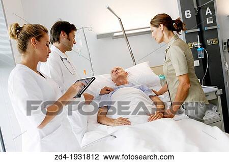 Stock Image - doctor attending to patient in hospital room, Onkologikoa Hospital, Oncology Institute, Case Center for prevention, diagnosis and treatment of cancer, Donostia, San Sebastian, Gipuzkoa, Basque Country, Spain. Fotosearch