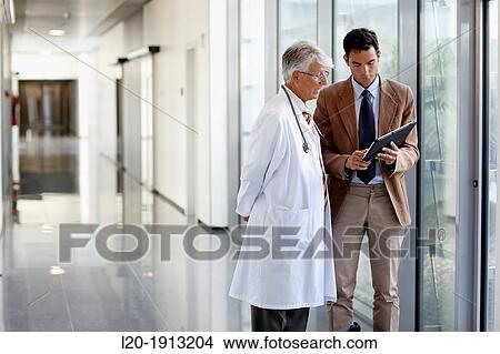 Doctor attending to seller, Corridor, Onkologikoa Hospital, Oncology Institute, Case Center for prevention, diagnosis and treatment of cancer, Donostia, San Sebastian, Gipuzkoa, Basque Country, Spain View Large Photo Image Picture - Doctor attending to seller, Corridor, Onkologikoa Hospital, Oncology Institute, Case Center for prevention, diagnosis and treatment of cancer, Donostia, San Sebastian, Gipuzkoa, Basque Country, Spain. Fotosearch