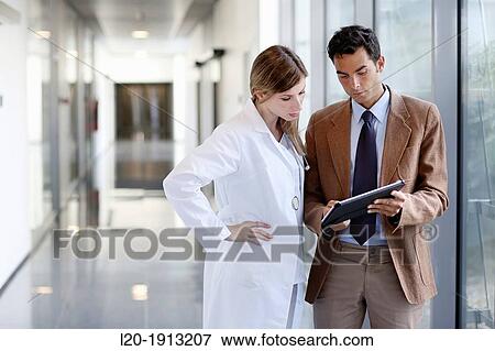 Doctor attending to seller, Corridor, Onkologikoa Hospital, Oncology Institute, Case Center for prevention, diagnosis and treatment of cancer, Donostia, San Sebastian, Gipuzkoa, Basque Country, Spain View Large Photo Image Stock Photo - Doctor attending to seller, Corridor, Onkologikoa Hospital, Oncology Institute, Case Center for prevention, diagnosis and treatment of cancer, Donostia, San Sebastian, Gipuzkoa, Basque Country, Spain. Fotosearch