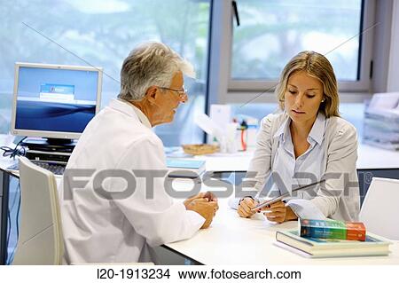 Picture - Doctor attending to seller, Tablet, Consulting room, Onkologikoa Hospital, Oncology Institute, Case Center for prevention, diagnosis and treatment of cancer, Donostia, San Sebastian, Gipuzkoa, Basque Country, Spain. Fotosearch
