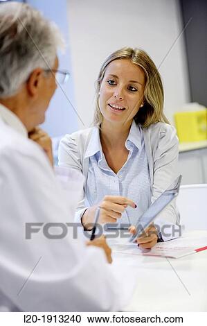 Stock Image - Doctor attending to seller, Tablet, Consulting room, Onkologikoa Hospital, Oncology Institute, Case Center for prevention, diagnosis and treatment of cancer, Donostia, San Sebastian, Gipuzkoa, Basque Country, Spain. Fotosearch