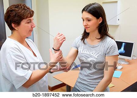 Doctor checking arm flexion strength, Physiotherapy medical center, Donostia, San Sebastian, Gipuzkoa, Basque Country, Spain View Large Photo Image Stock Image - Doctor checking arm flexion strength, Physiotherapy medical center, Donostia, San Sebastian, Gipuzkoa, Basque Country, Spain. Fotosearch