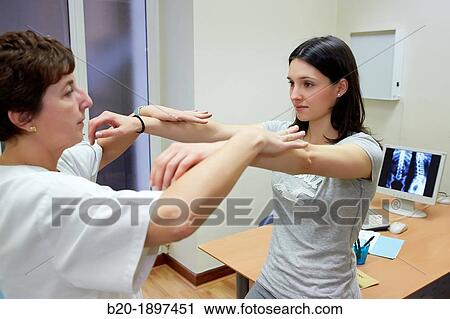 Stock Image - Doctor checking back-arms force Column X-ray image, Physiotherapy medical center, Donostia, San Sebastian, Gipuzkoa, Basque Country, Spain. Fotosearch