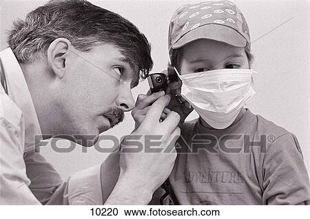 Doctor checking the ears of a child with leukaemia View Large Photo Image Stock Image - Doctor checking the ears of a child with leukaemia. Fotosearch