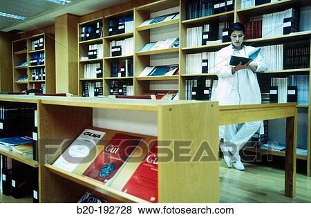Doctor consulting book View Large Photo Image Stock Photo - Doctor consulting book. Fotosearch