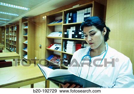 Doctor consulting book View Large Photo Image Stock Photo - Doctor consulting book. Fotosearch