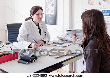 Stock Image - Doctor consultung a female patient.. Fotosearch
