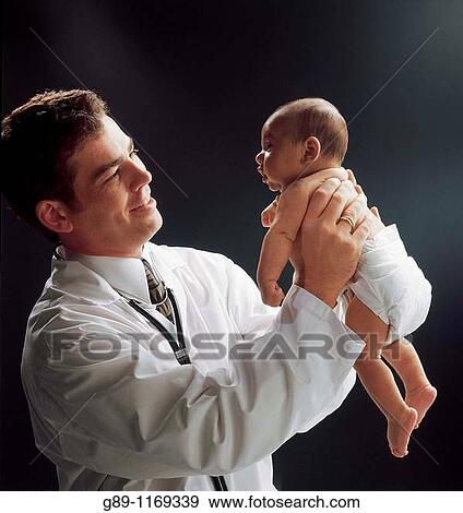 doctor examing infant View Large Photo Image Stock Photo - doctor examing infant. Fotosearch
