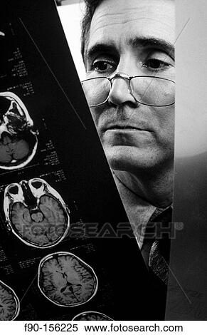 Doctor examining brain scan. View Large Photo Image Stock Photography - Doctor examining brain scan.. Fotosearch
