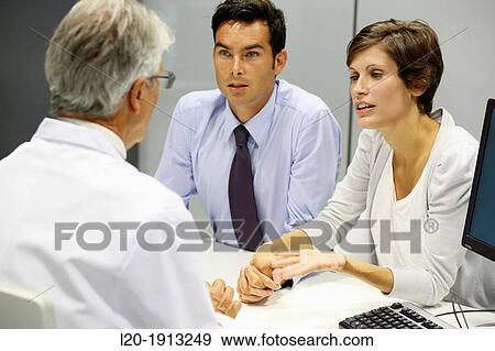 Stock Photo - Doctor, family, Consulting room, Onkologikoa Hospital, Oncology Institute, Case Center for prevention, diagnosis and treatment of cancer, Donostia, San Sebastian, Gipuzkoa, Basque Country, Spain. Fotosearch