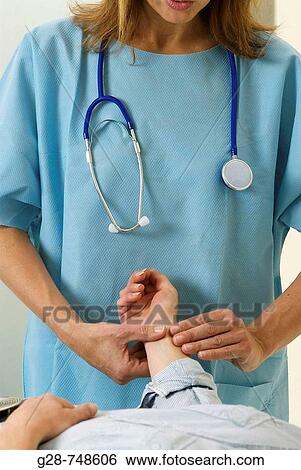 Stock Photograph - Doctor feeling patient? s pulse. Fotosearch