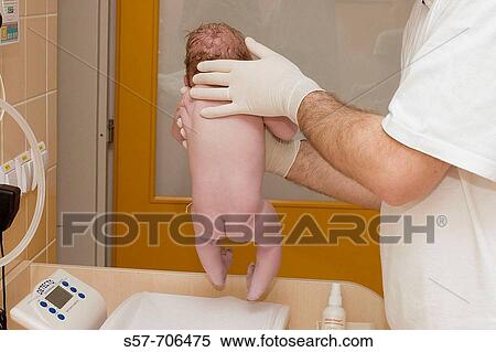 Doctor holdin new born baby - examining of walking reflex View Large Photo Image Stock Photography - Doctor holdin new born baby - examining of walking reflex. Fotosearch