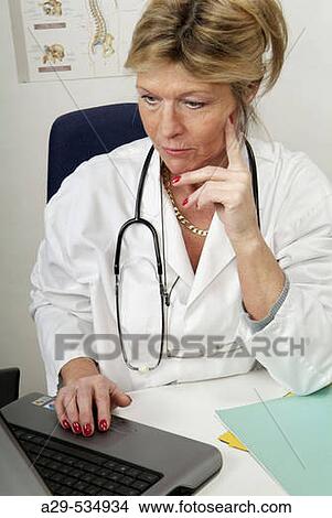 Doctor in her office View Large Photo Image Picture - Doctor in her office. Fotosearch