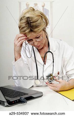 Doctor in her office View Large Photo Image Stock Photo - Doctor in her office. Fotosearch