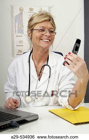 Doctor in her office View Large Photo Image Stock Photograph - Doctor in her office. Fotosearch