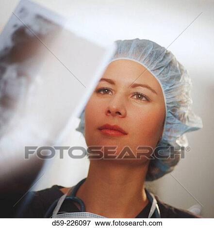 Stock Photo - Doctor looking at x-rays. Fotosearch