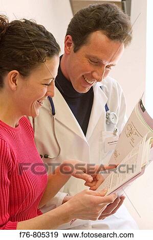 Doctor, reviewing medical charts with female patient, in medical office View Large Photo Image Stock Photo - Doctor, reviewing medical charts with female patient, in medical office. Fotosearch