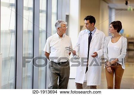 Doctor talking with the patient's family in the hospital corridor, Onkologikoa Hospital, Oncology Institute, Case Center for prevention, diagnosis and treatment of cancer, Donostia, San Sebastian, Gipuzkoa, Basque Country, Spain View Large Photo Image Picture - Doctor talking with the patient's family in the hospital corridor, Onkologikoa Hospital, Oncology Institute, Case Center for prevention, diagnosis and treatment of cancer, Donostia, San Sebastian, Gipuzkoa, Basque Country, Spain. Fotosearch