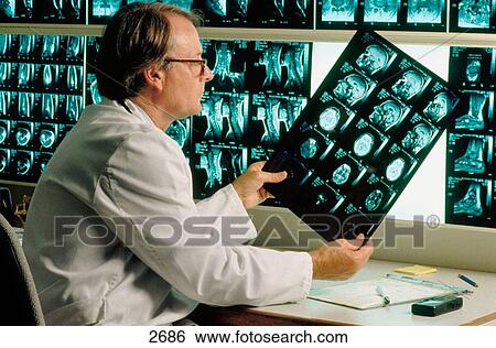 Doctor with magnetic resonance images View Large Photo Image Stock Photograph - Doctor with magnetic resonance images. Fotosearch