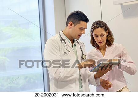 Doctor with patient in waiting room, Onkologikoa Hospital, Oncology Institute, Case Center for prevention, diagnosis and treatment of cancer, Donostia, San Sebastian, Gipuzkoa, Basque Country, Spain. View Large Photo Image Stock Image - Doctor with patient in waiting room, Onkologikoa Hospital, Oncology Institute, Case Center for prevention, diagnosis and treatment of cancer, Donostia, San Sebastian, Gipuzkoa, Basque Country, Spain.. Fotosearch
