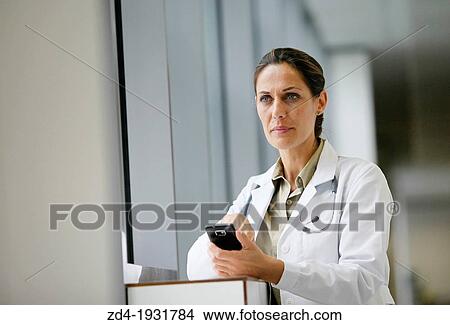 Doctor with smartphone in corridor, Onkologikoa Hospital, Oncology Institute, Case Center for prevention, diagnosis and treatment of cancer, Donostia, San Sebastian, Gipuzkoa, Basque Country, Spain View Large Photo Image Picture - Doctor with smartphone in corridor, Onkologikoa Hospital, Oncology Institute, Case Center for prevention, diagnosis and treatment of cancer, Donostia, San Sebastian, Gipuzkoa, Basque Country, Spain. Fotosearch
