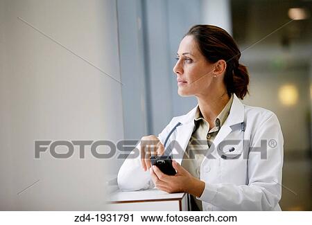 Doctor with smartphone in corridor, Onkologikoa Hospital, Oncology Institute, Case Center for prevention, diagnosis and treatment of cancer, Donostia, San Sebastian, Gipuzkoa, Basque Country, Spain View Large Photo Image Stock Image - Doctor with smartphone in corridor, Onkologikoa Hospital, Oncology Institute, Case Center for prevention, diagnosis and treatment of cancer, Donostia, San Sebastian, Gipuzkoa, Basque Country, Spain. Fotosearch